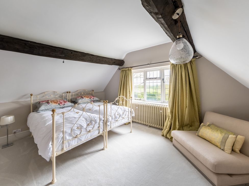 A bedroom with a bed and sofa at Hall O'Coole in Broomhall nearn Wrenbury