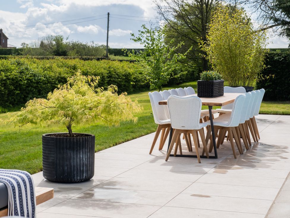 An outdoor dining area with a table and chairs at Hall O'Coole Broomhall nearn Wrenbury