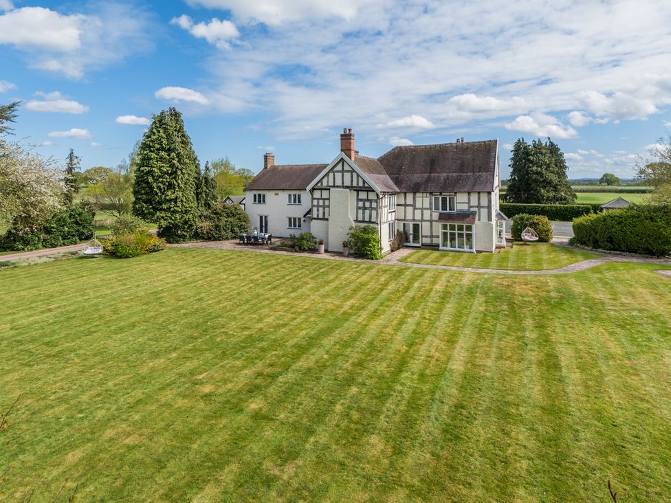 A house with a garden and trees at Hall O'Coole in Broomhall nearn Wrenbury