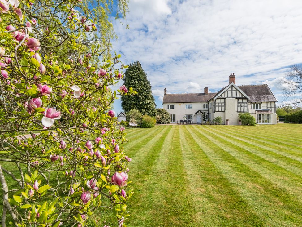 A house with a garden and flowers at Hall O'Coole in Broomhall nearn Wrenbury