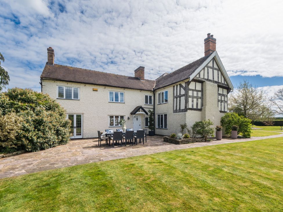 A house with a garden and outdoor furniture at Hall O'Coole in Broomhall nearn Wrenbury