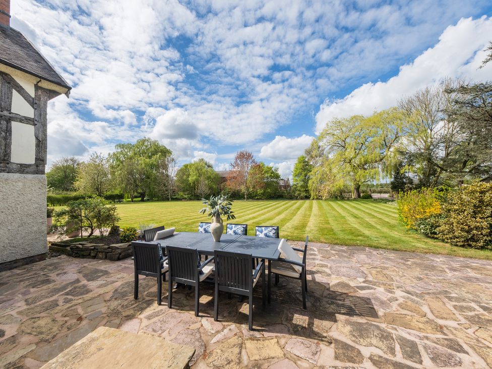 An outdoor dining area with a table and chairs at Hall O'Coole in Broomhall nearn Wrenbury
