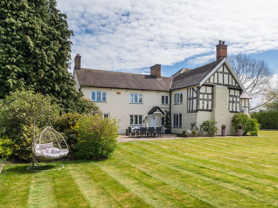 A house with a swing in the garden at Hall O'Coole Broomhall nearn Wrenbury