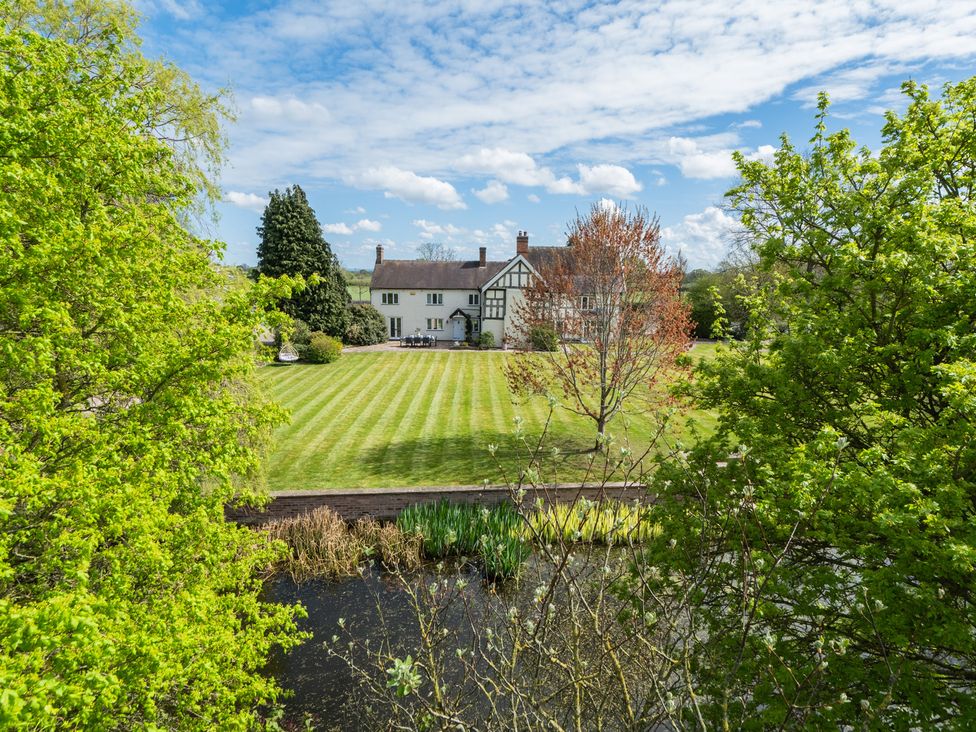 A house with a garden and pond at Hall O'Coole in Broomhall near Wrenbury