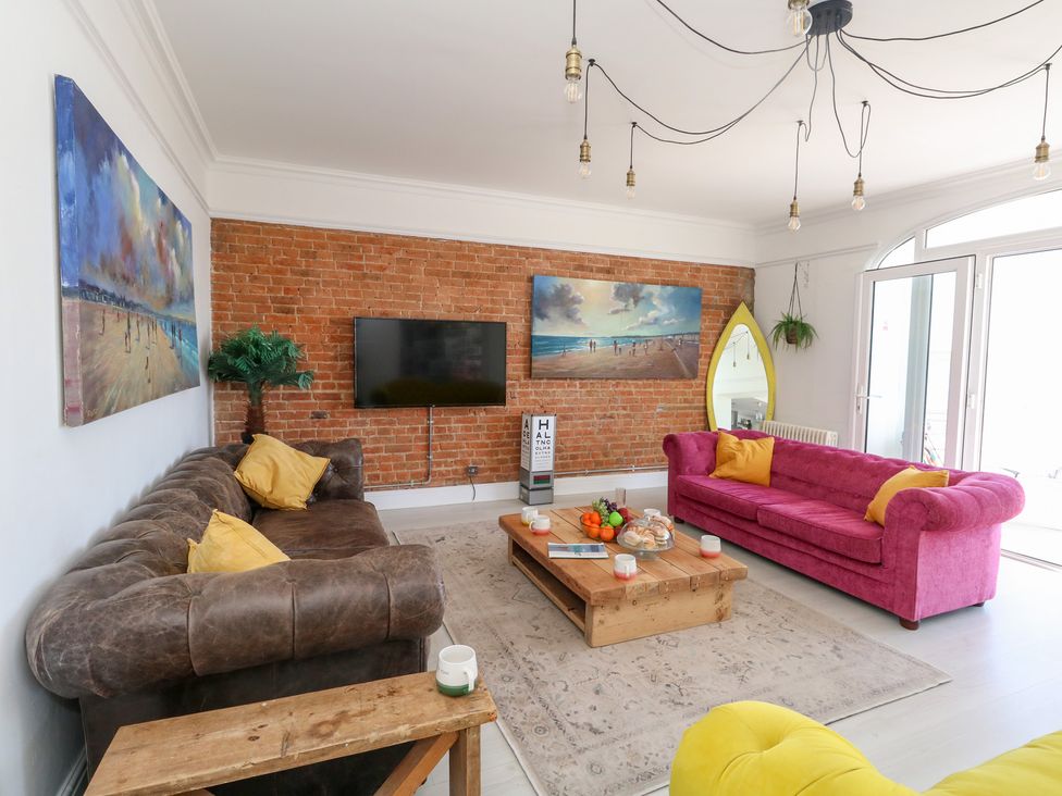 A living room with a sofa and coffee table at The Beach Condo in Weymouth