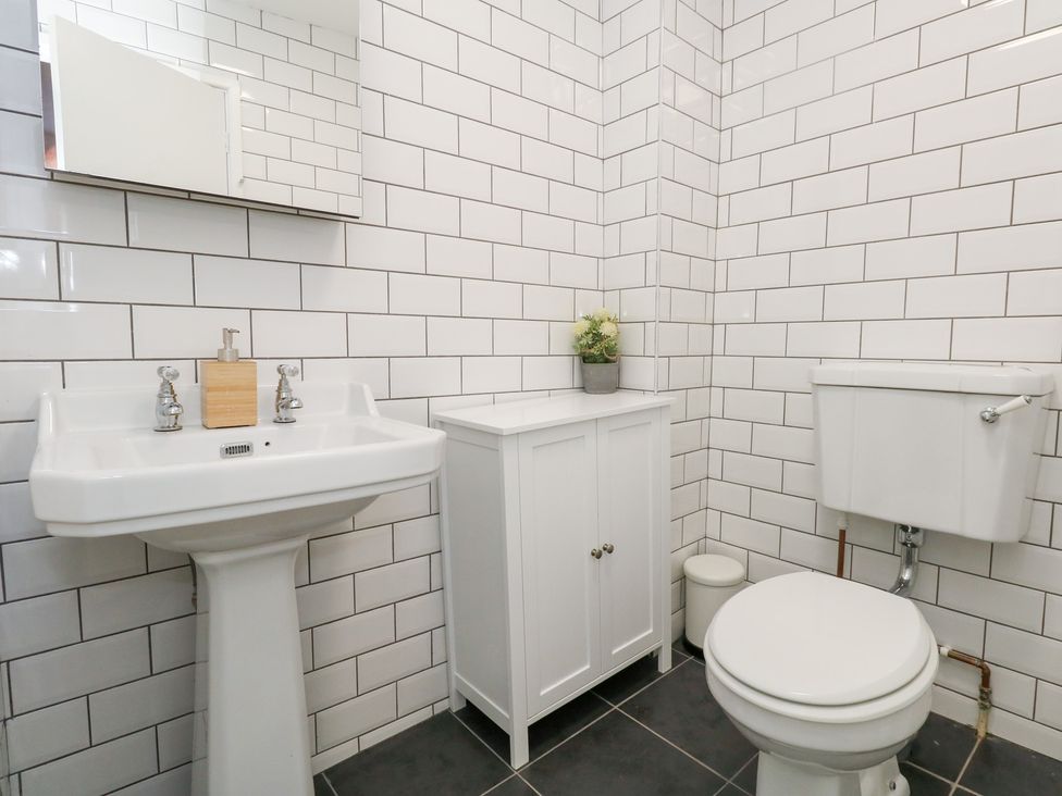 A bathroom with a sink and toilet at The Beach Condo in Weymouth