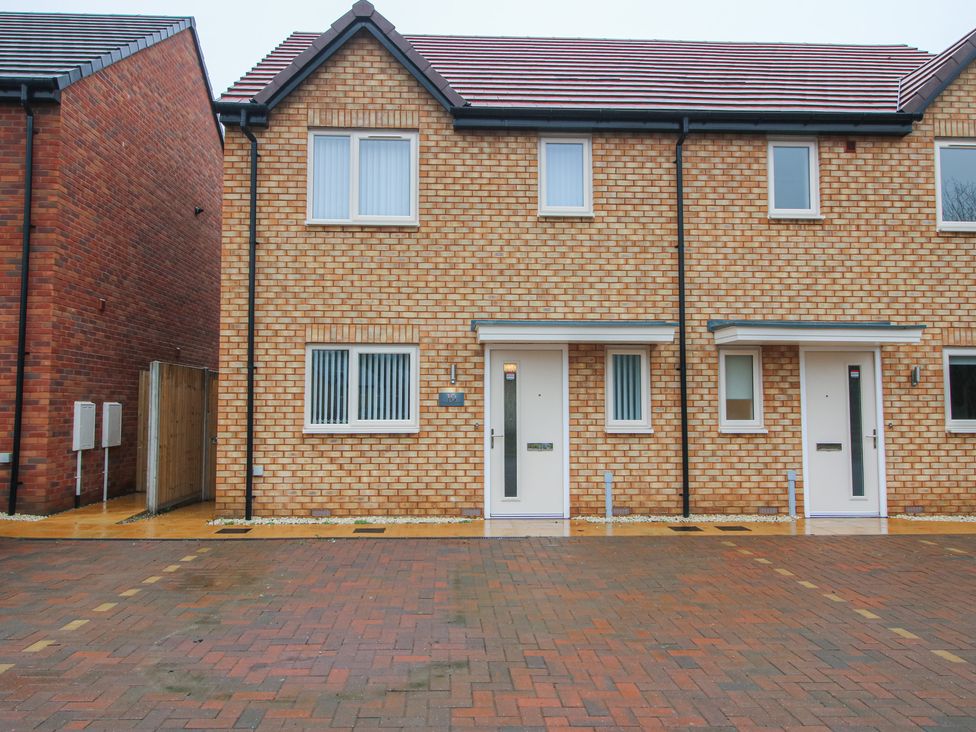 A brick house with entrance doors and parking area at 10 The Colliery Telford