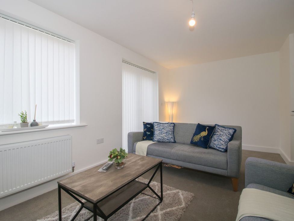 A living room with a sofa and coffee table at 10 The Colliery in Telford