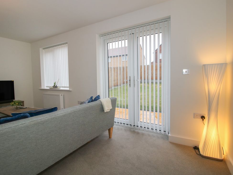 A living room with a sofa and television at 10 The Colliery in Telford