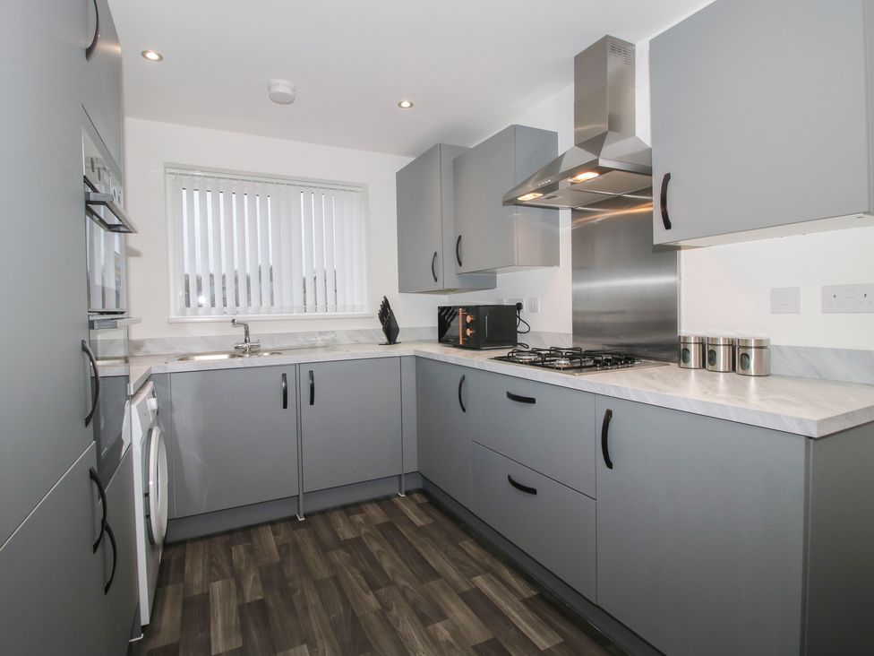 A kitchen with grey cabinets and appliances at 10 The Colliery Telford