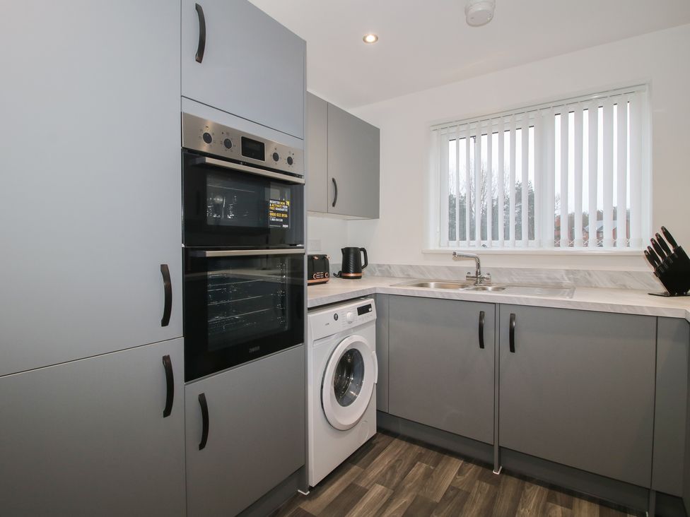 A kitchen with appliances and countertops at 10 The Colliery in Telford