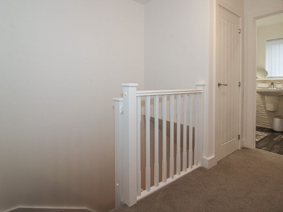 A staircase leading to a bathroom with a sink in 10 The Colliery Telford