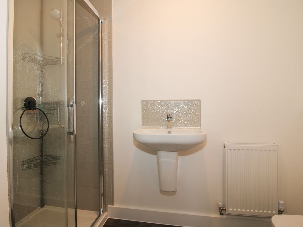 A bathroom with a shower and sink at 10 The Colliery Telford