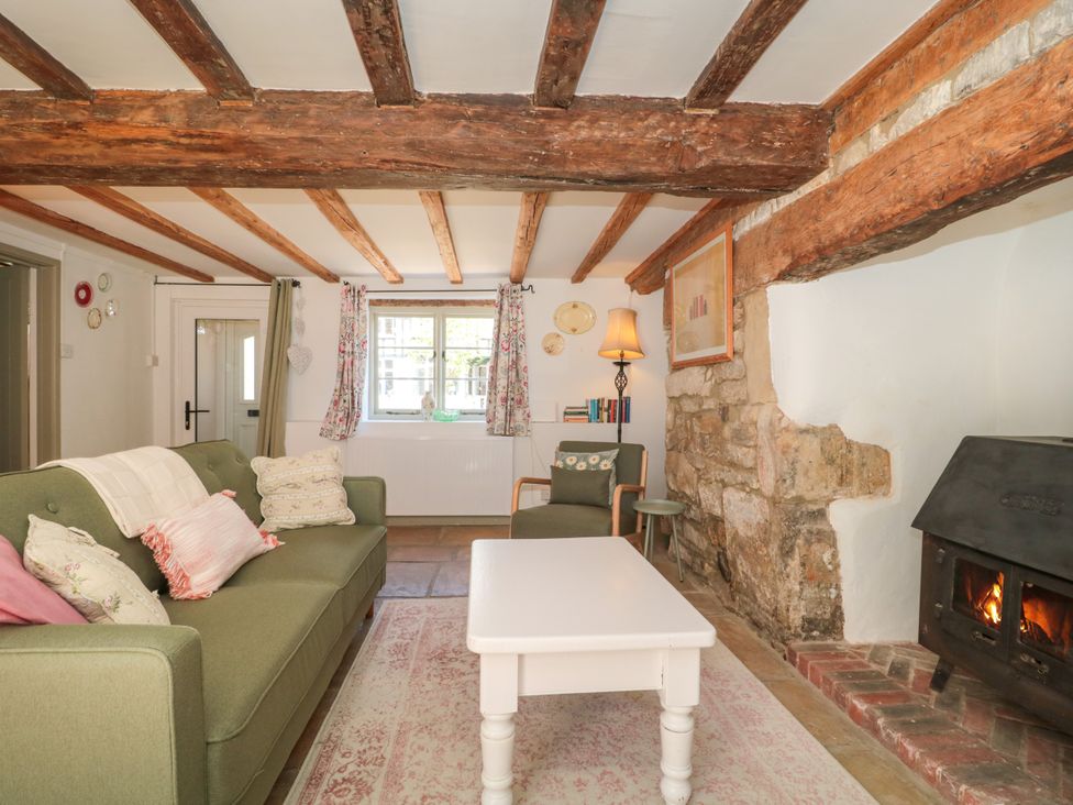 A living room with a sofa and coffee table at Old Farm Cottage Warminster