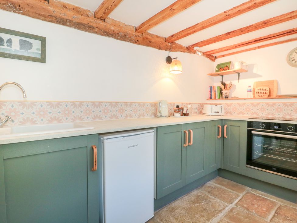 A kitchen with appliances and a countertop at Old Farm Cottage in Warminster
