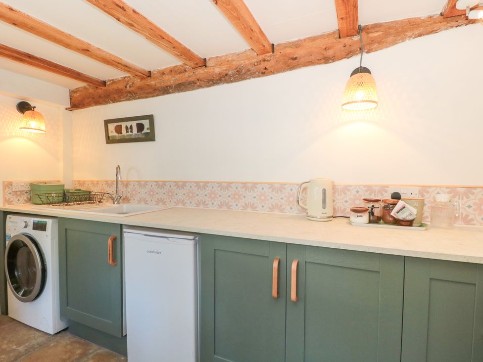 A laundry room with a washing machine and a sink at Old Farm Cottage Warminster