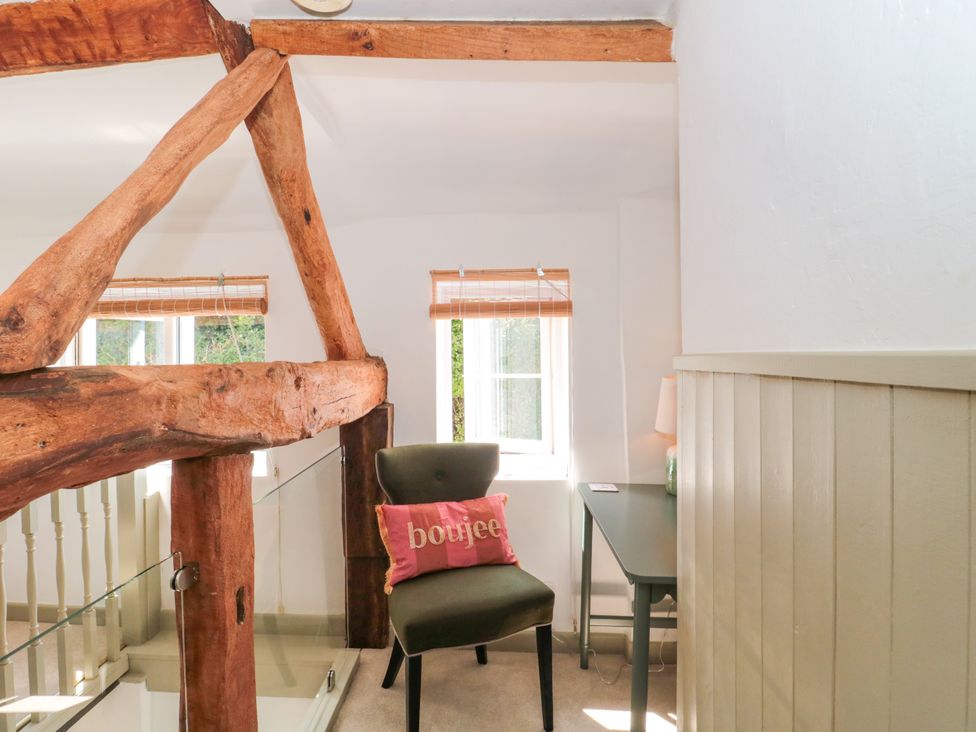 An office space with a chair and desk at Old Farm Cottage in Warminster