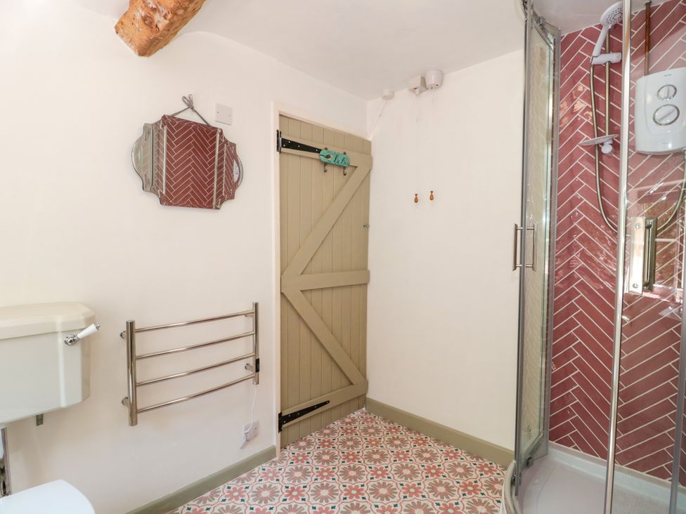 A bathroom with a shower and toilet at Old Farm Cottage in Warminster