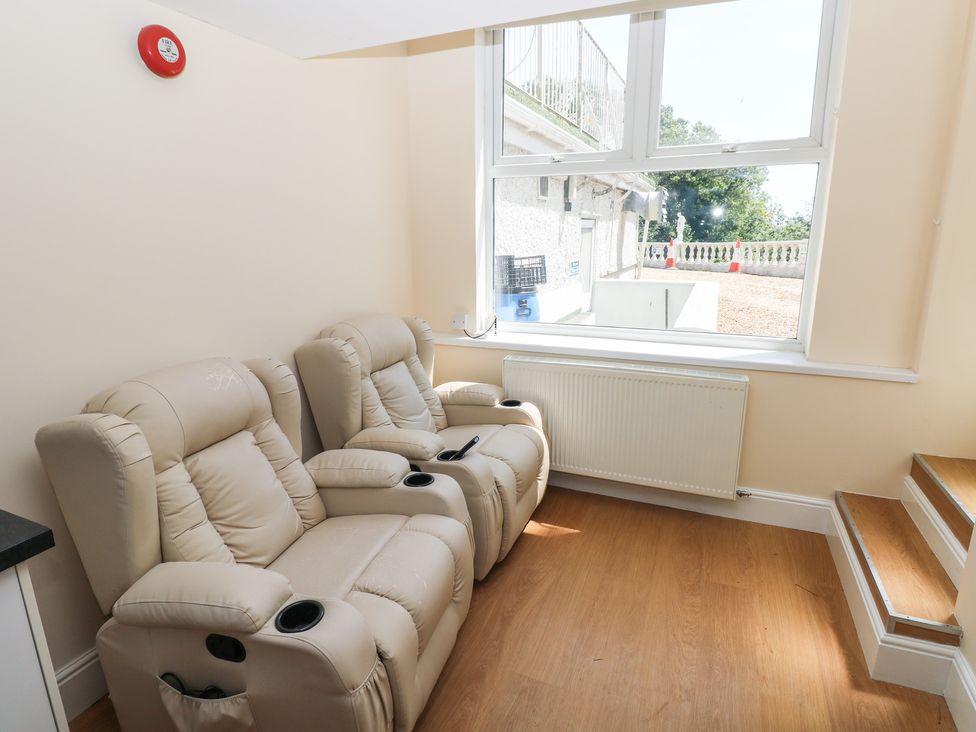 A snug with recliner chairs and a window at Whiteshell in Langland near Mumbles
