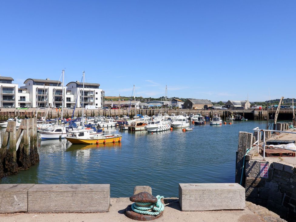 A marina with boats and buildings at 2 Bredy Cottages, Burton Bradstock