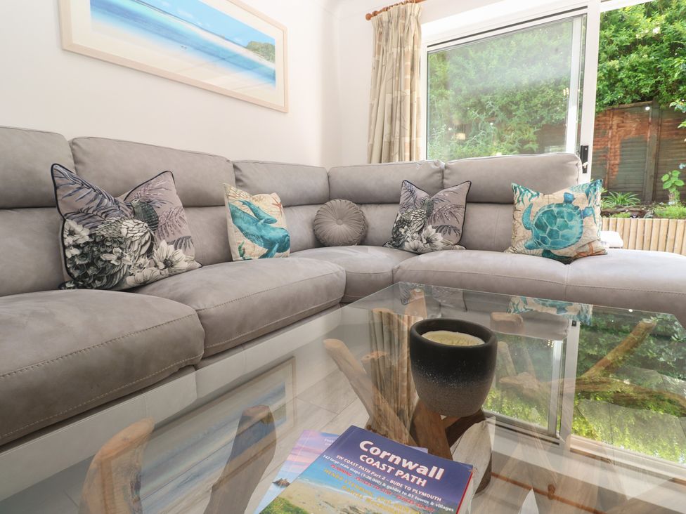 A living room with a sofa and a coffee table at Jaluna in Carbis Bay