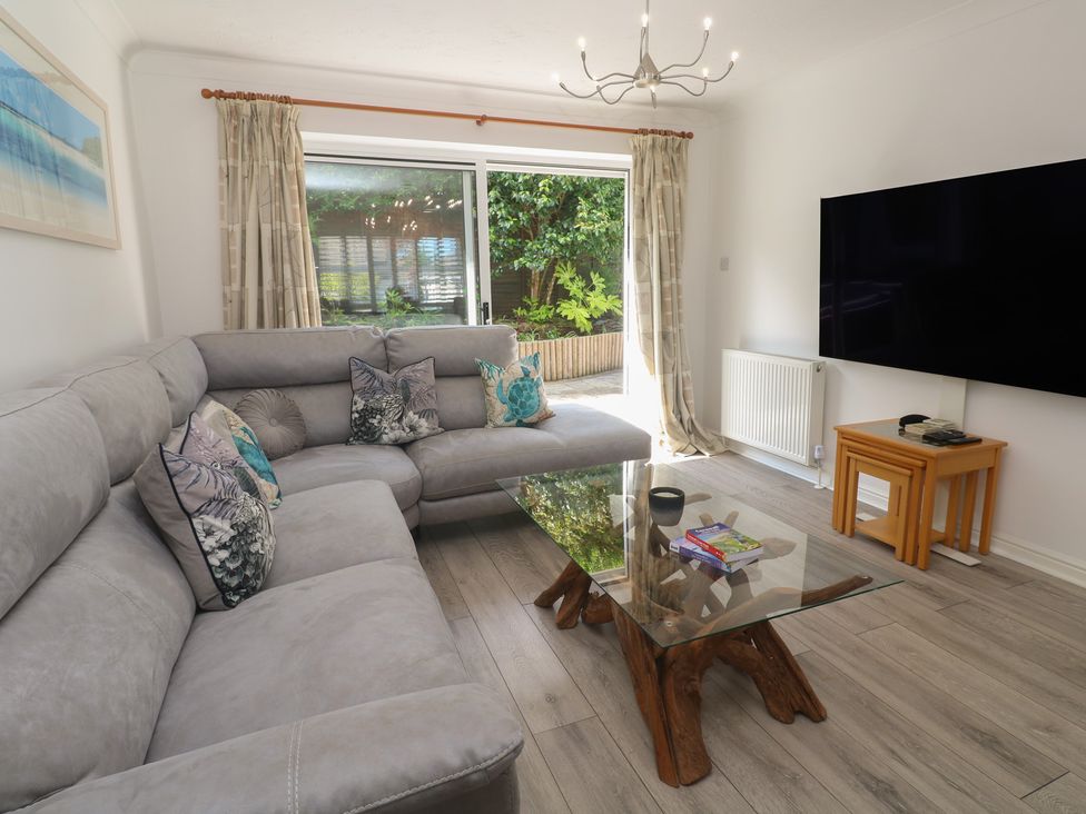 A living room with a sofa and coffee table at Jaluna in Carbis Bay