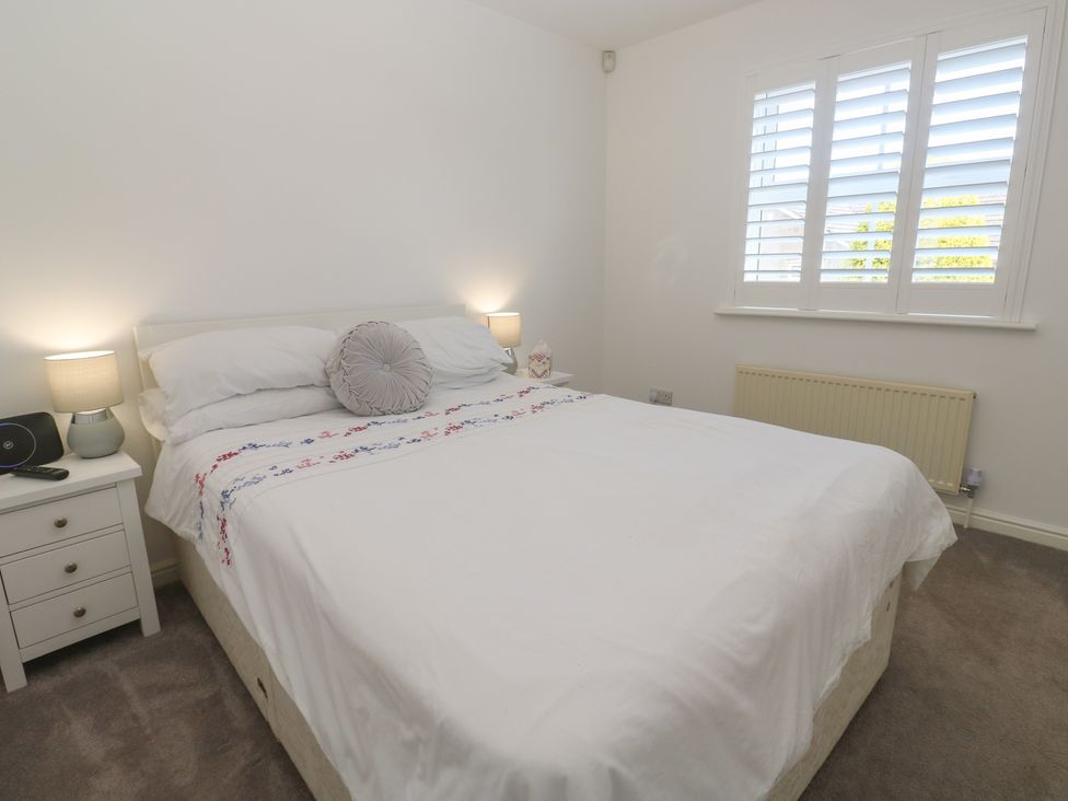 A bedroom with a bed and bedside table at Jaluna in Carbis Bay