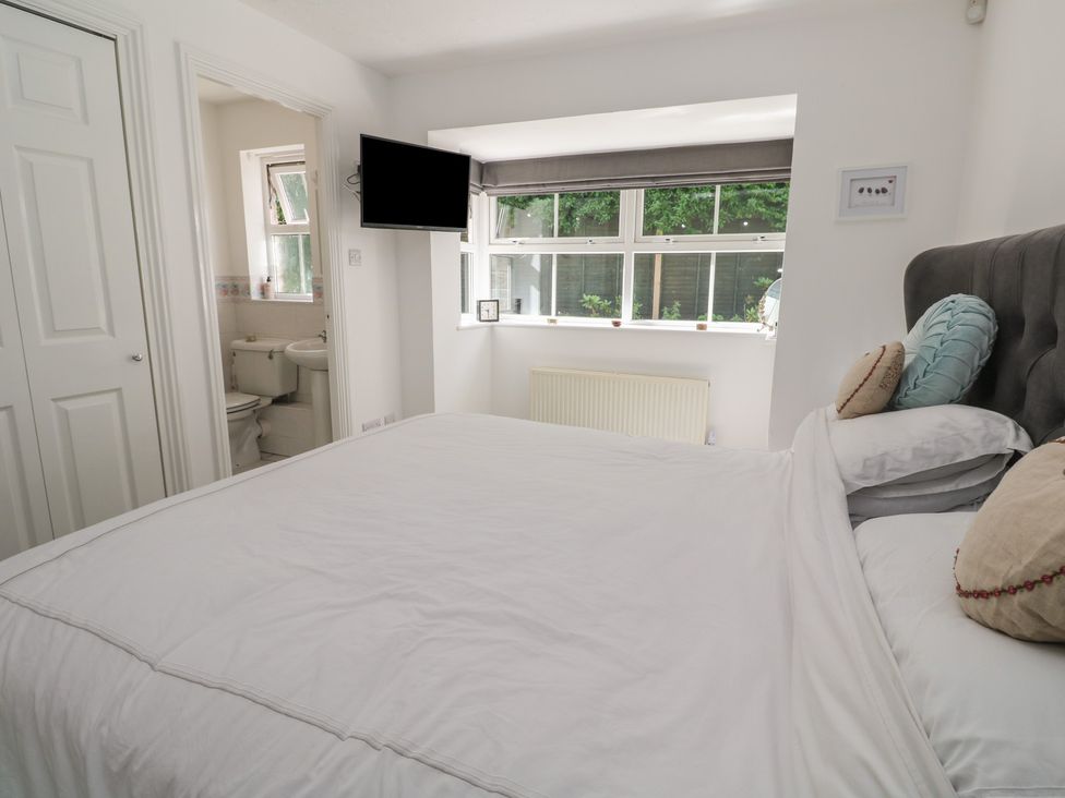 A bedroom with a bed and television at Jaluna Carbis Bay
