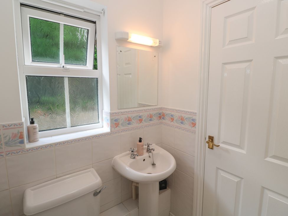A bathroom with a sink and toilet at Jaluna in Carbis Bay