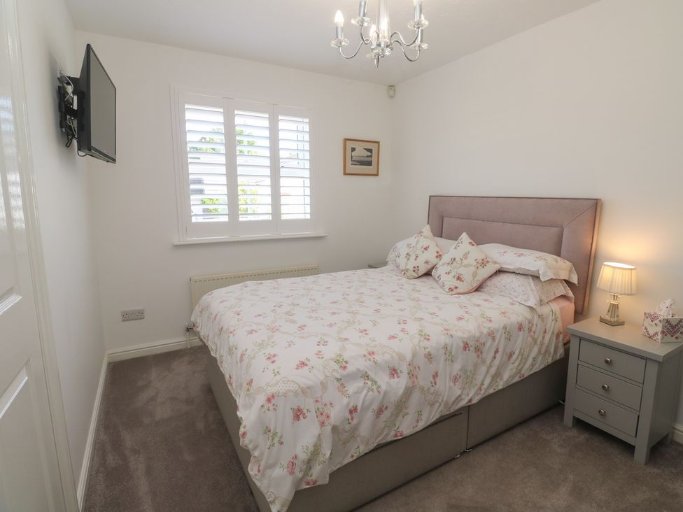A bedroom with a bed and a television at Jaluna in Carbis Bay