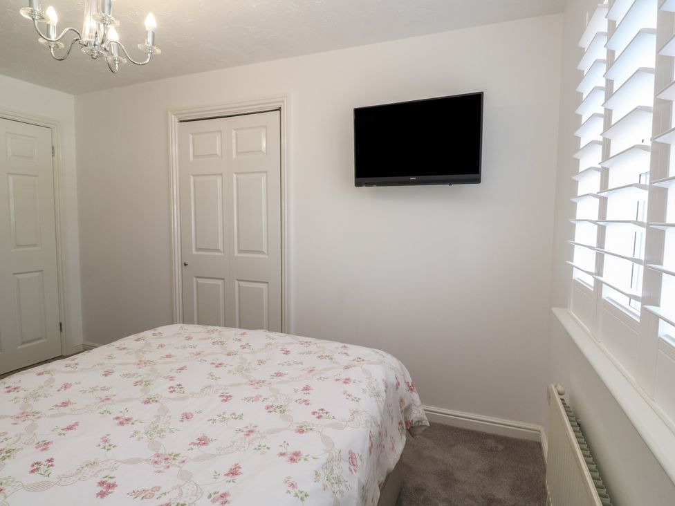 A bedroom with a bed and television at Jaluna in Carbis Bay