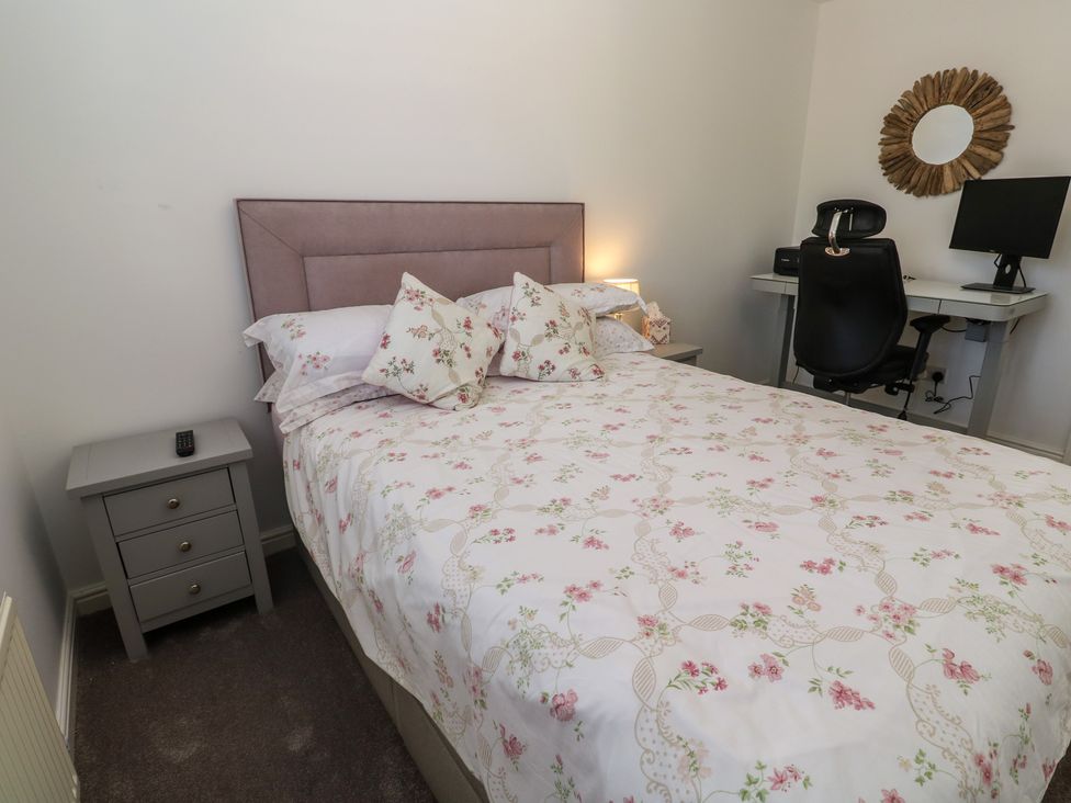 A bedroom with a bed and desk at Jaluna in Carbis Bay