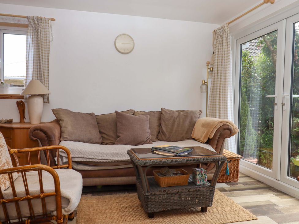 A living room with a sofa and coffee table at Rowan in Brixham