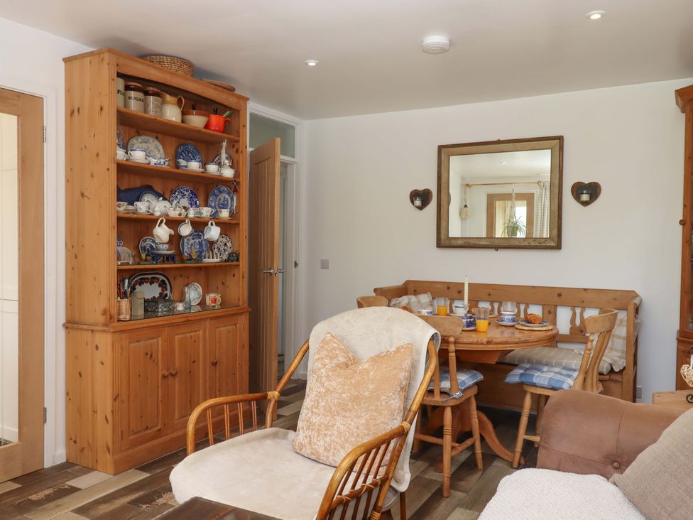 A dining room with a table and chairs at Rowan in Brixham
