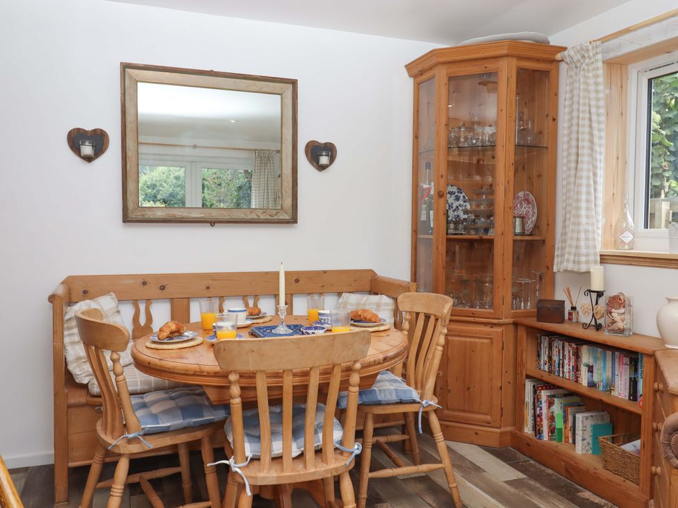 A dining room with a table and chairs at Rowan in Brixham