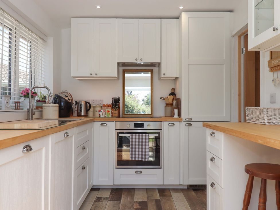 A kitchen with cabinets and an oven at Rowan in Brixham