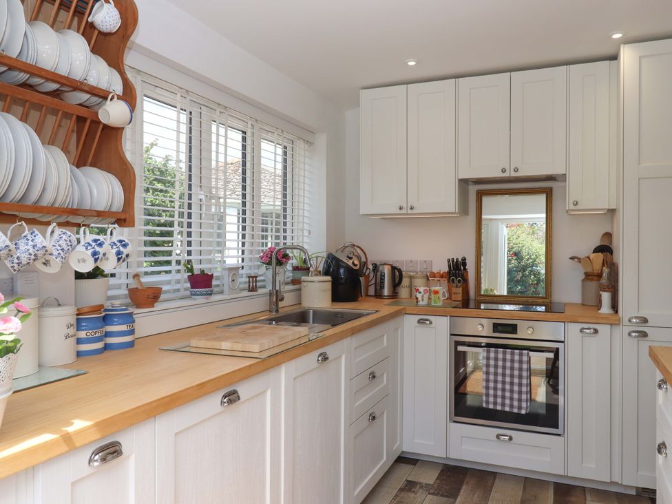 A kitchen with shelves and kitchenware at Rowan in Brixham
