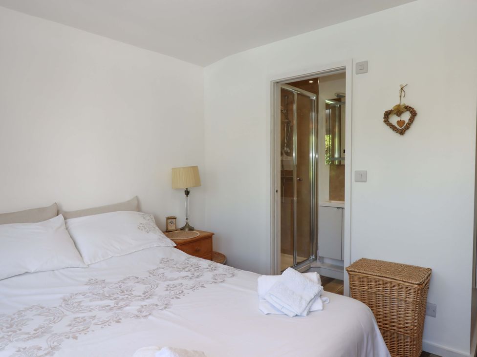 A bedroom with a bed and shower at Rowan in Brixham