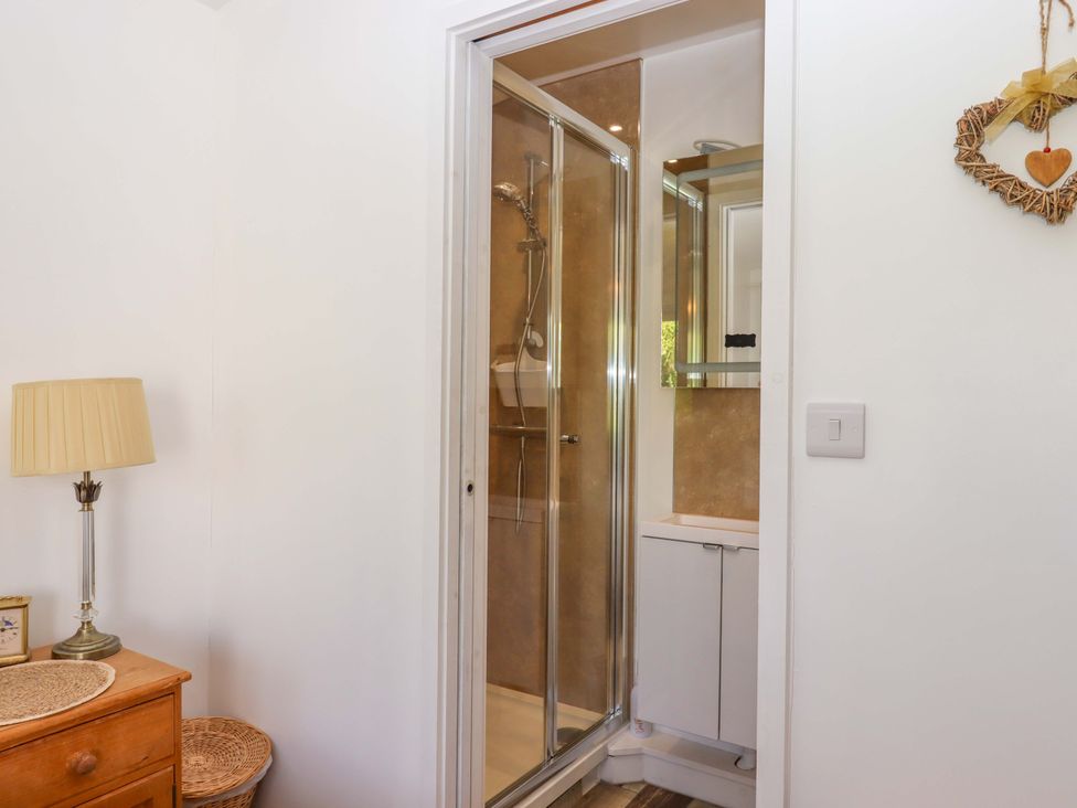 A bathroom with a shower and vanity at Rowan in Brixham