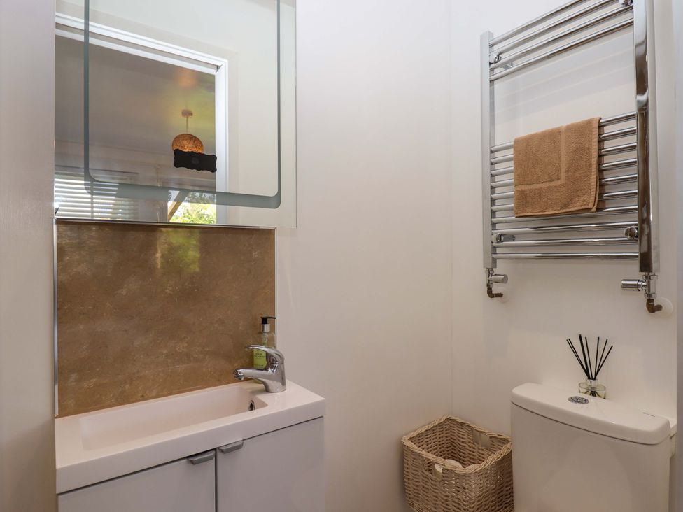 A bathroom with a sink and a towel rack at Rowan in Brixham