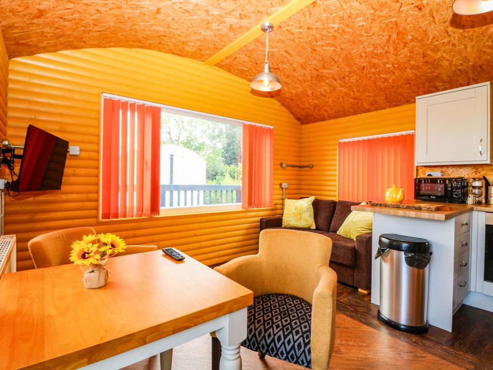 A living room with furniture and kitchen unit at Ava Lodge in West Mains near Haggerston