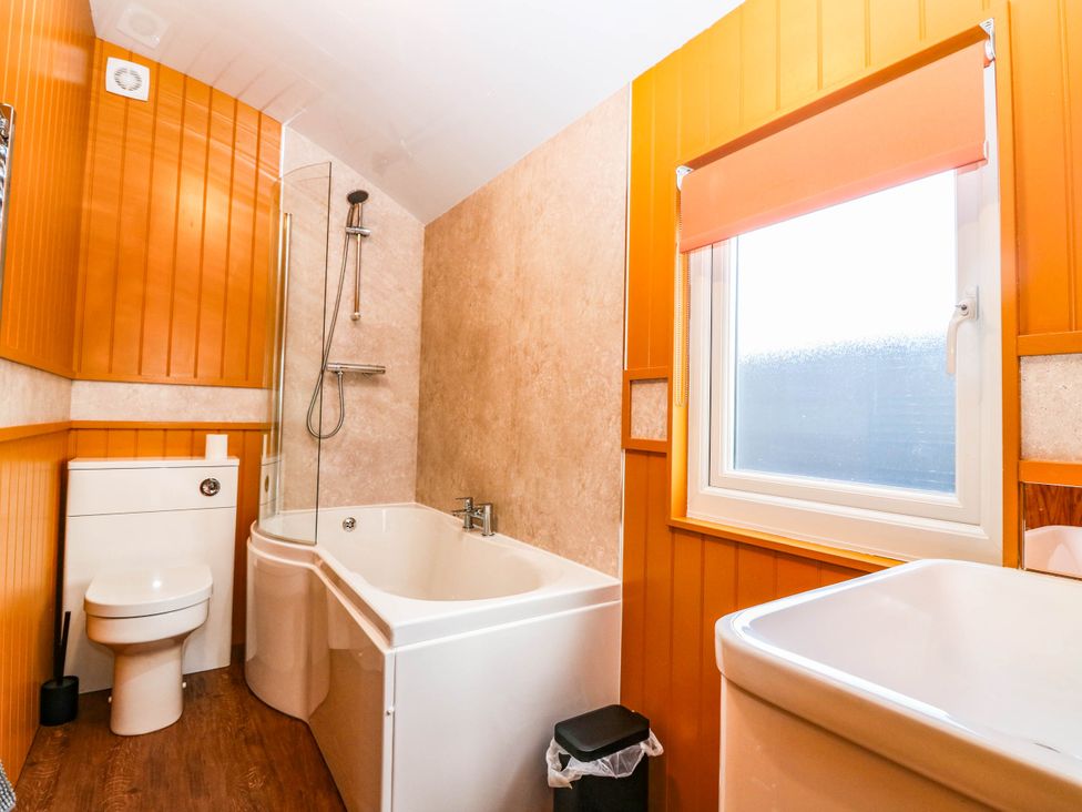 A bathroom with a bathtub and shower at Ava Lodge in West Mains near Haggerston
