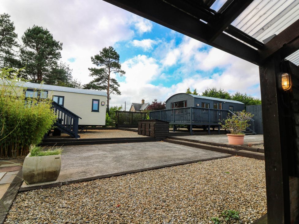 An outdoor area with mobile homes and a gravel path at Ava Lodge in West Mains near Haggerston