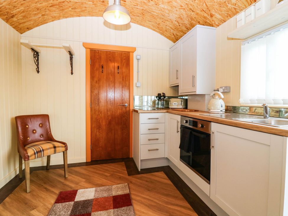 A kitchen with cabinets and counter space at Masons Hut in West Mains near Haggerston