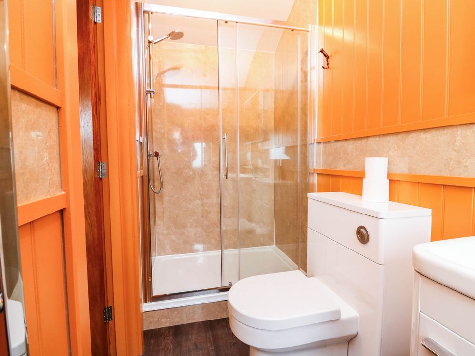 A bathroom with a shower and toilet at Masons Hut in West Mains near Haggerston