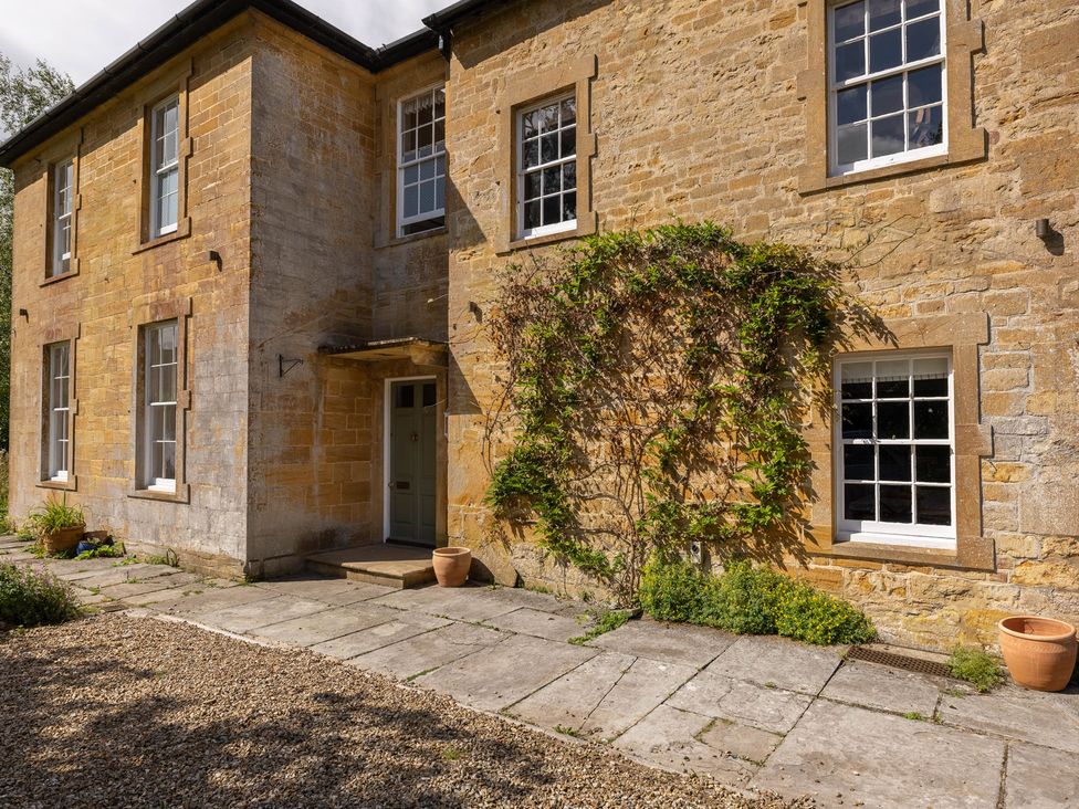 An exterior view of a house with a pathway and plants at The Old Vicarage in Merriott