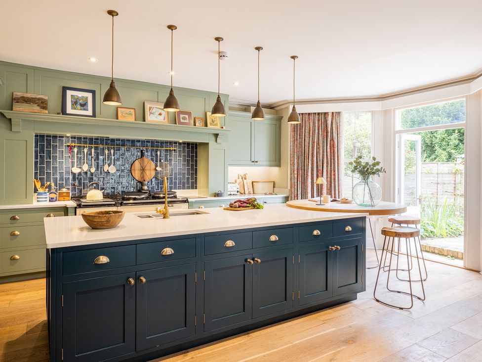A kitchen with an island and cabinets at The Old Vicarage in Merriott