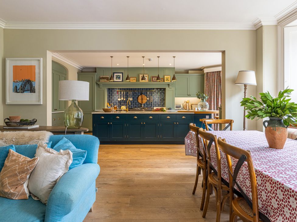 A kitchen with a seating area and dining table at The Old Vicarage in Merriott
