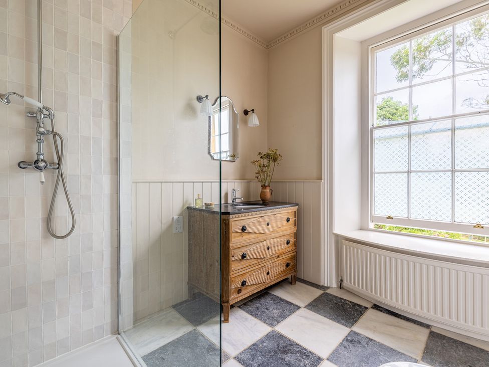 A bathroom with a shower and vanity at The Old Vicarage in Merriott