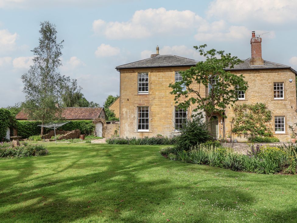 An outdoor view of a house with a garden at The Old Vicarage in Merriott
